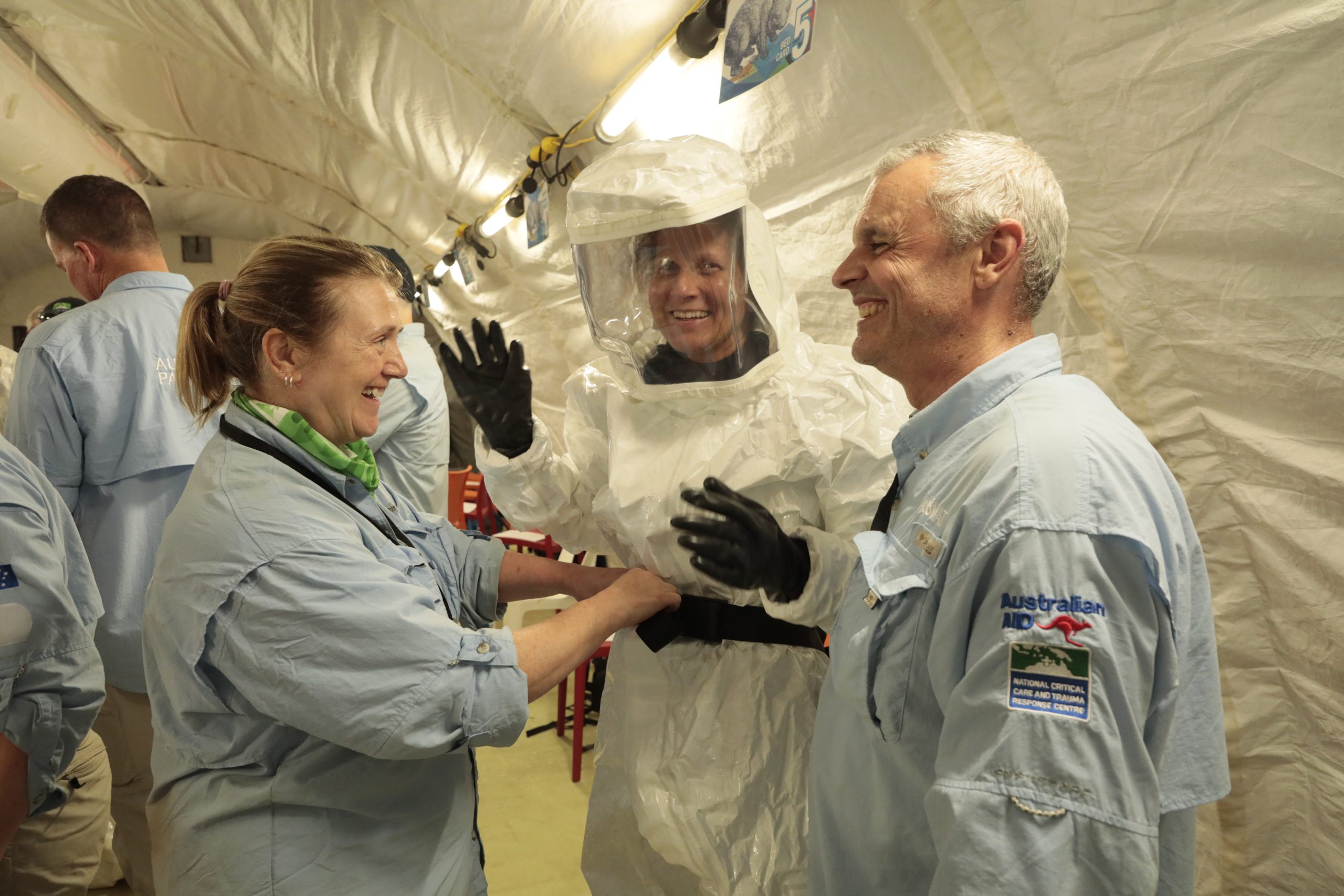 A group of people in a white tent.